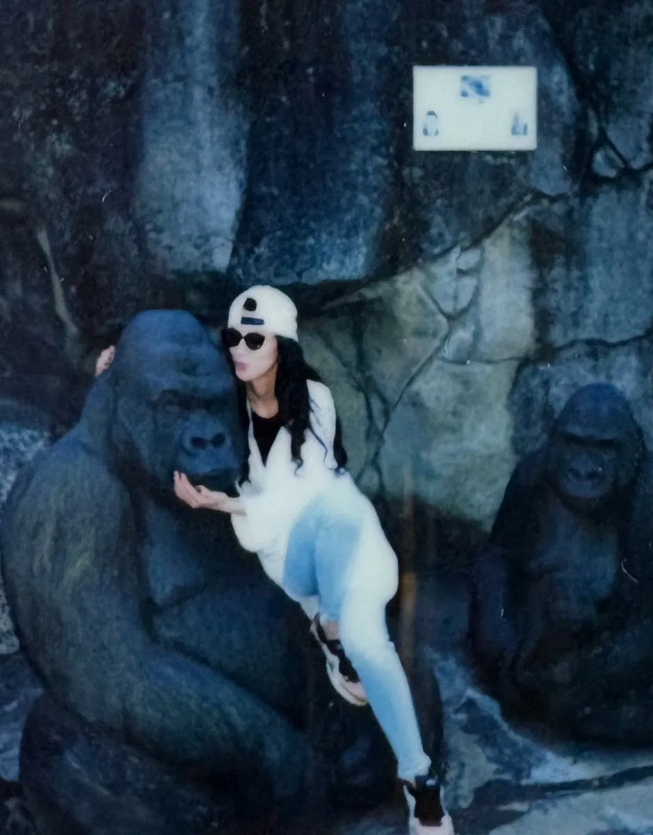 A teammate with a gorilla statue at the zoo