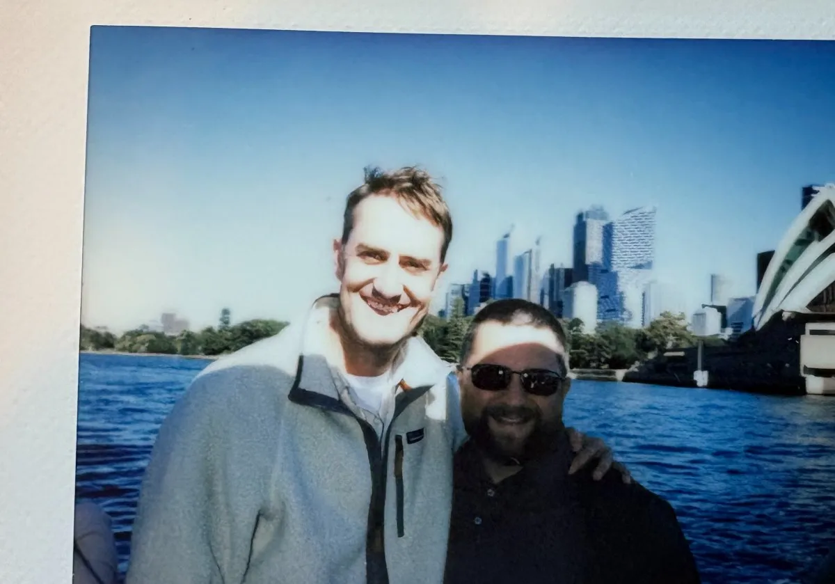 Two teammates by Sydney harbour with the Opera House in the background
