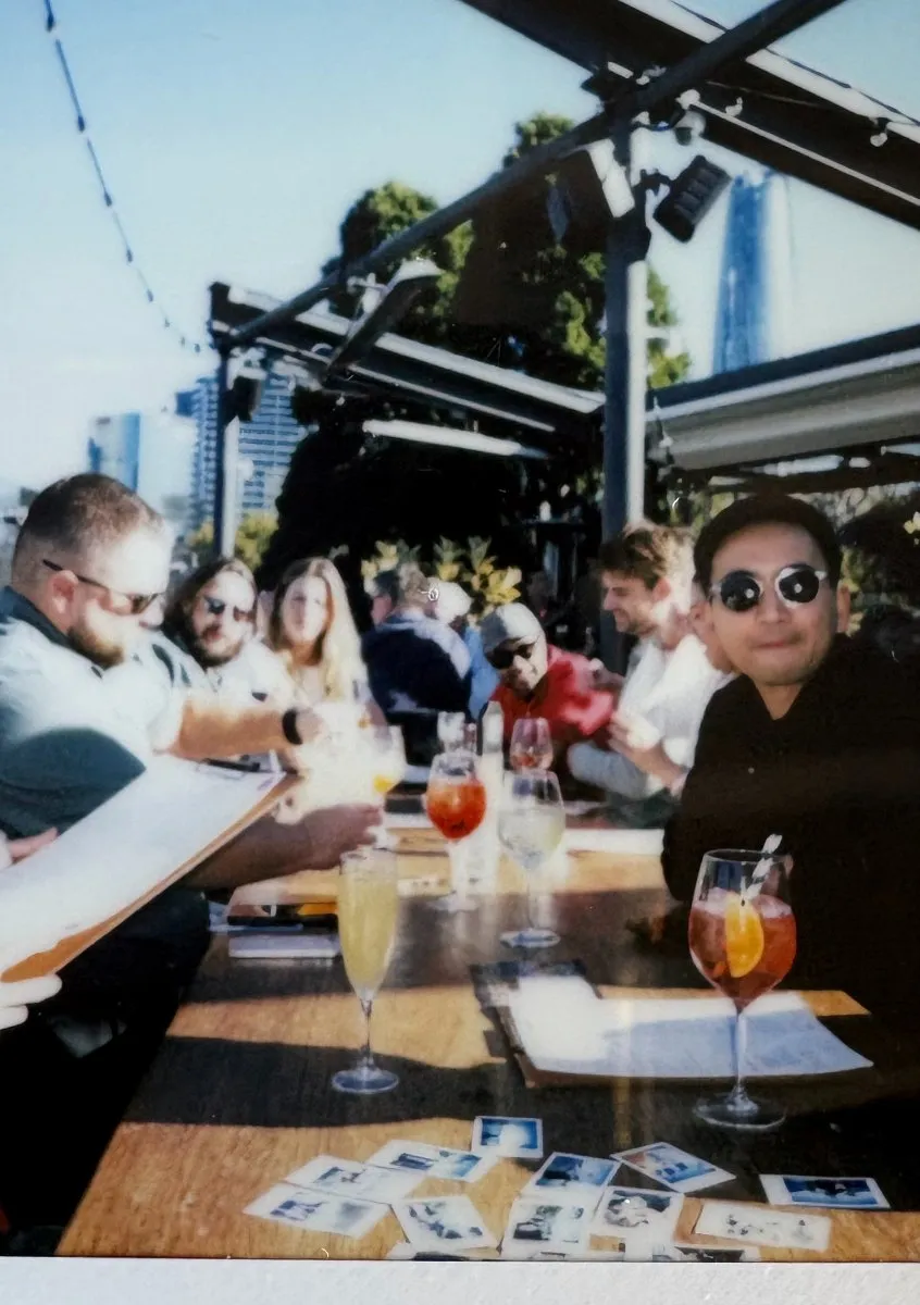Table of cocktails and polaroids at the off-site